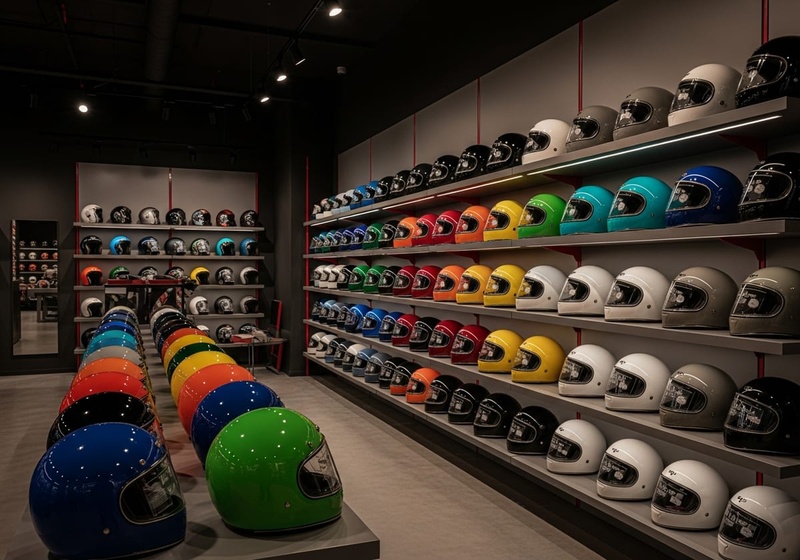 interior de tienda de cascos de moto con estanterías llenas – outlet cascos Valencia